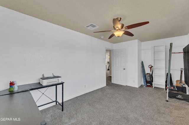 workout room featuring ceiling fan, carpet floors, and baseboards
