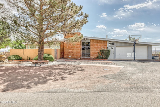8024 Tonto Pl, El Paso, TX 79904 - view of front of house with an attached garage, driveway, brick siding, and fence