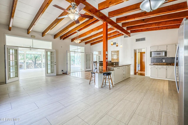 8024 Tonto Pl, El Paso, TX 79904 - kitchen featuring freestanding refrigerator, ceiling fan, open floor plan, a peninsula, and beamed ceiling