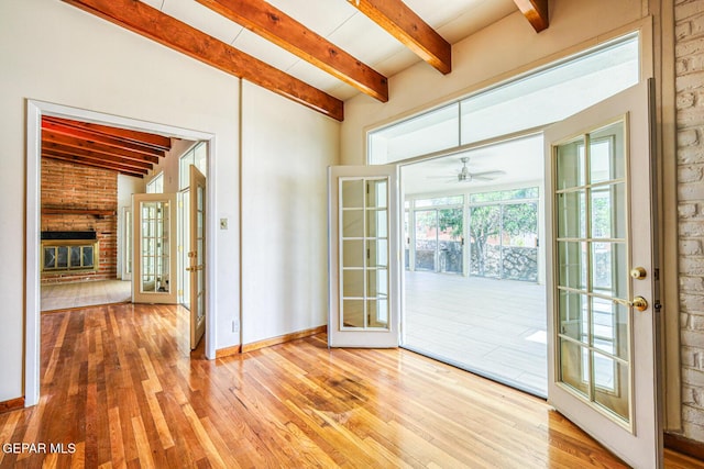 8024 Tonto Pl, El Paso, TX 79904 - doorway to outside with beamed ceiling, hardwood / wood-style flooring, french doors, a fireplace, and baseboards