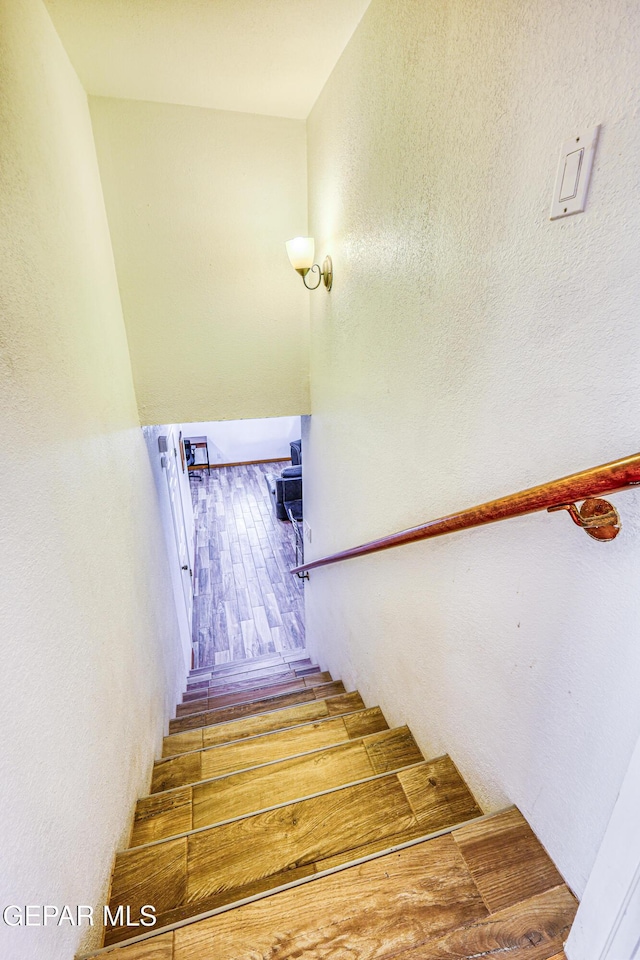 8024 Tonto Pl, El Paso, TX 79904 - stairs featuring a textured wall and wood finished floors
