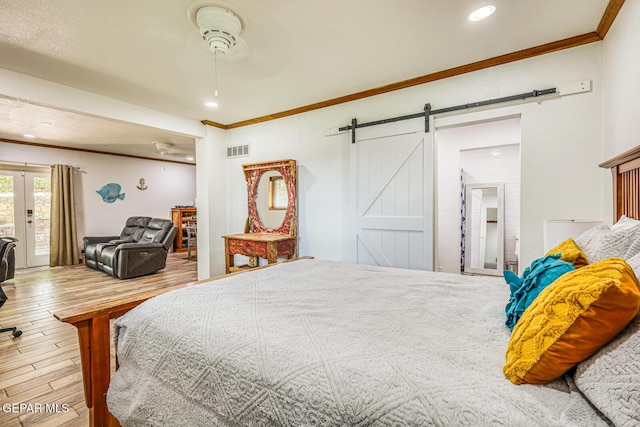 8024 Tonto Pl, El Paso, TX 79904 - bedroom featuring crown molding, a barn door, wood finished floors, recessed lighting, and access to outside