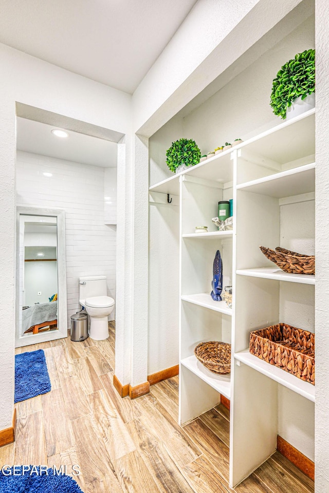 8024 Tonto Pl, El Paso, TX 79904 - bathroom with wood finished floors, baseboards, and toilet