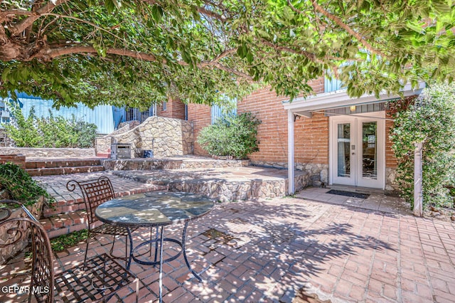 8024 Tonto Pl, El Paso, TX 79904 - view of patio / terrace featuring french doors and exterior fireplace