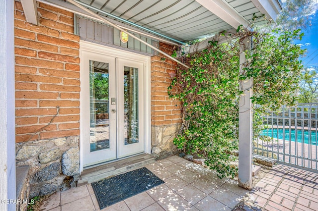 8024 Tonto Pl, El Paso, TX 79904 - entrance to property featuring french doors, brick siding, and fence