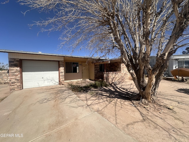 9603 Bahamas St, El Paso, TX 79927 - view of front of property with an attached garage, driveway, and brick siding