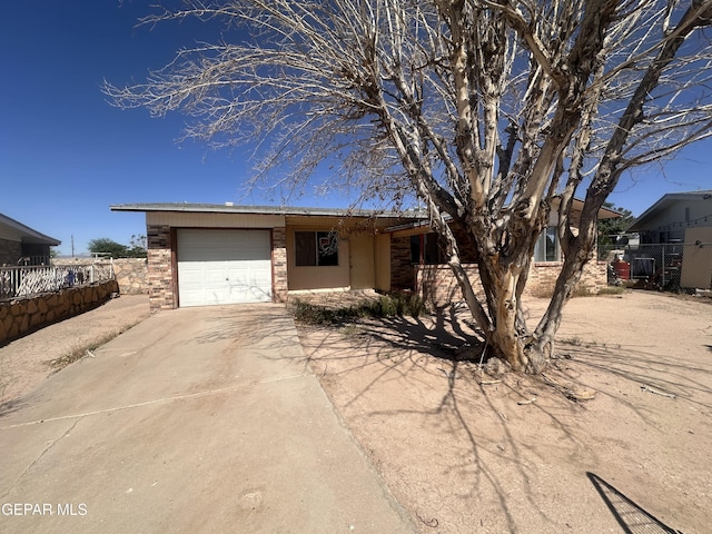 9603 Bahamas St, El Paso, TX 79927 - view of front of home featuring a garage, driveway, brick siding, and fence