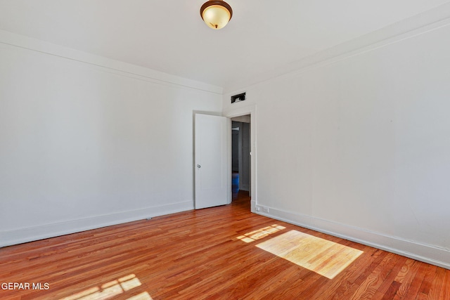 empty room with light wood-style floors and baseboards