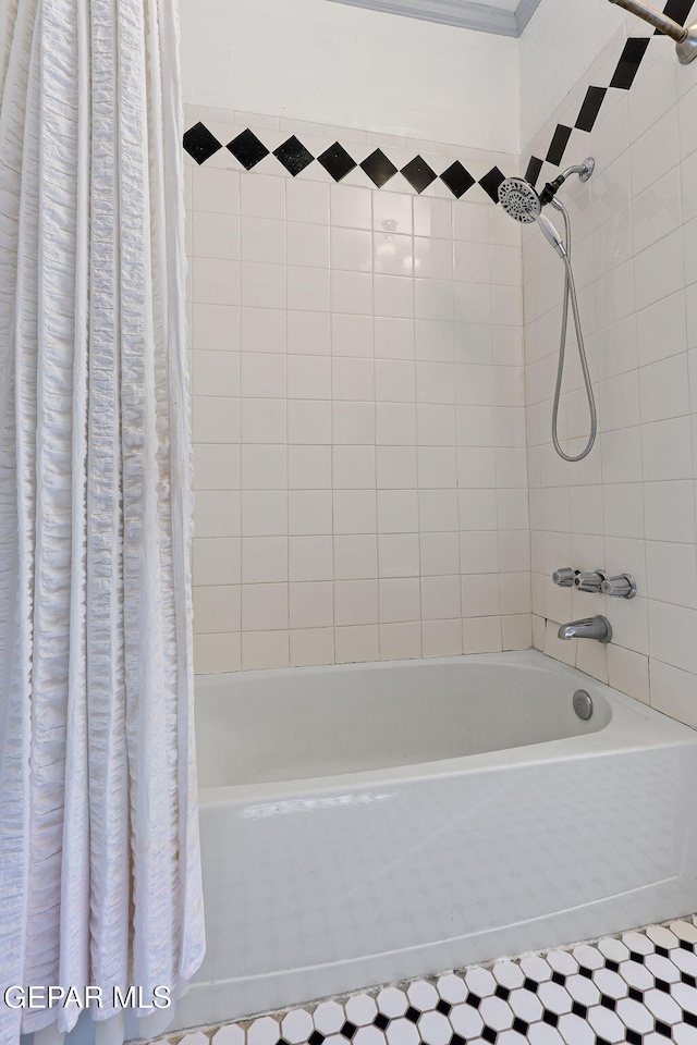 bathroom with shower / bath combo with shower curtain and tile patterned floors