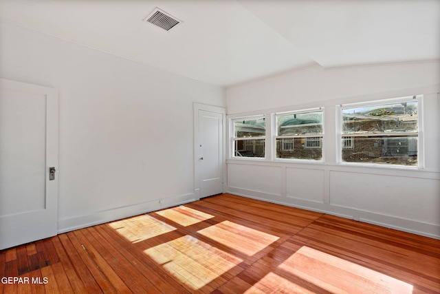 empty room with hardwood / wood-style flooring