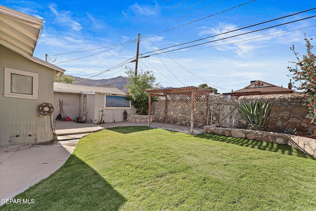 view of yard featuring a pergola, a patio area, and a mountain view