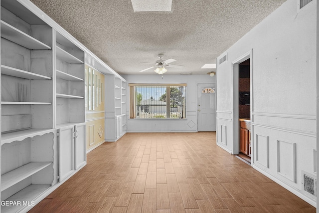 hallway featuring a textured ceiling and wood finished floors