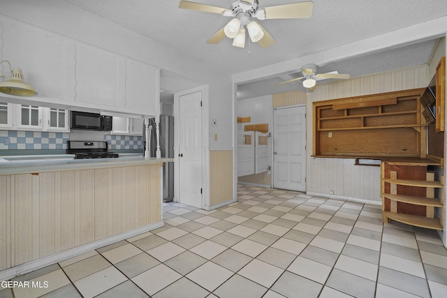 kitchen featuring stainless steel appliances, white cabinetry, ceiling fan, light countertops, and decorative backsplash