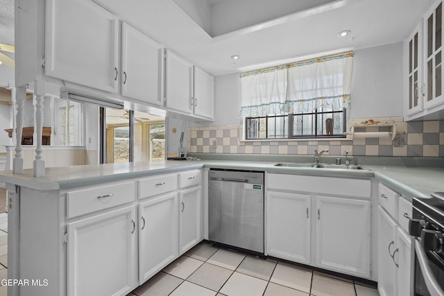 kitchen featuring dishwasher, a sink, range, white cabinets, and recessed lighting