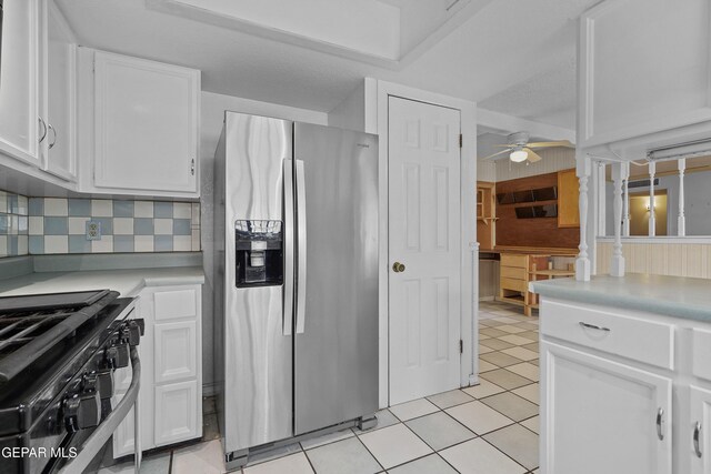 kitchen featuring stainless steel refrigerator with ice dispenser, white cabinetry, a ceiling fan, light countertops, and tasteful backsplash