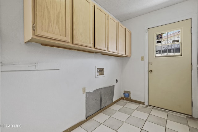 laundry area with cabinet space, electric dryer hookup, washer hookup, a textured ceiling, and baseboards