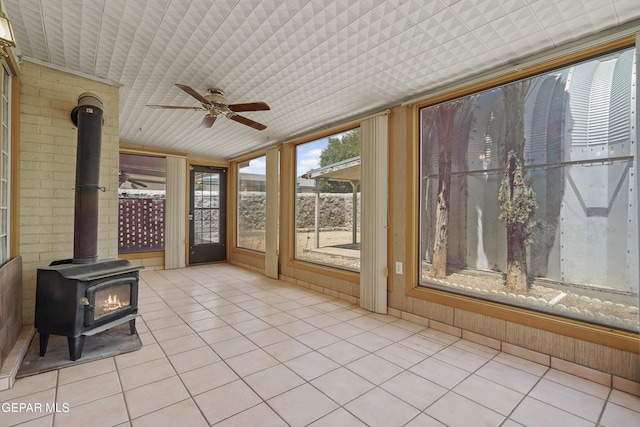 unfurnished sunroom with a wood stove
