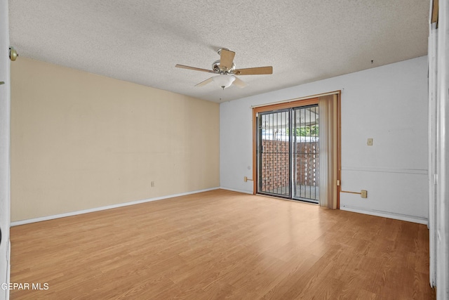 empty room with a ceiling fan, light wood-style floors, a textured ceiling, and baseboards