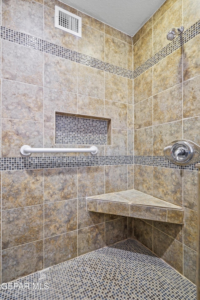 bathroom with a tile shower