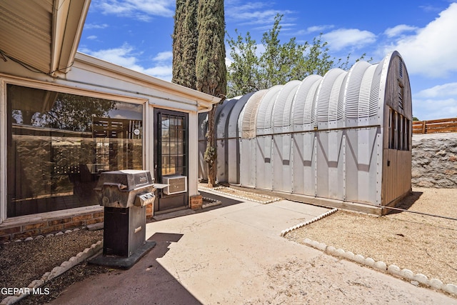 view of patio with a grill and fence