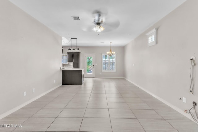 3096 Java Chip Pl, El Paso, TX 79938 - unfurnished living room with plenty of natural light, a chandelier, light tile patterned flooring, and a ceiling fan