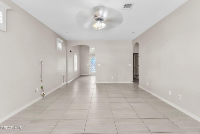 3096 Java Chip Pl, El Paso, TX 79938 - empty room with arched walkways, ceiling fan, light tile patterned floors, and baseboards
