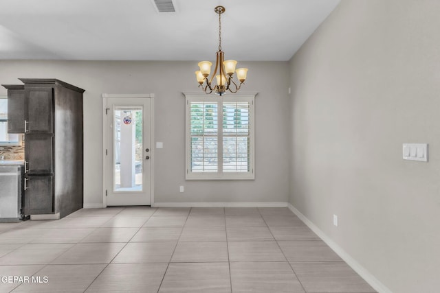 3096 Java Chip Pl, El Paso, TX 79938 - unfurnished dining area featuring light tile patterned flooring, a chandelier, and baseboards