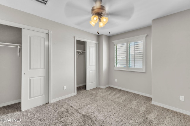 3096 Java Chip Pl, El Paso, TX 79938 - unfurnished bedroom featuring two closets, carpet, baseboards, and a ceiling fan