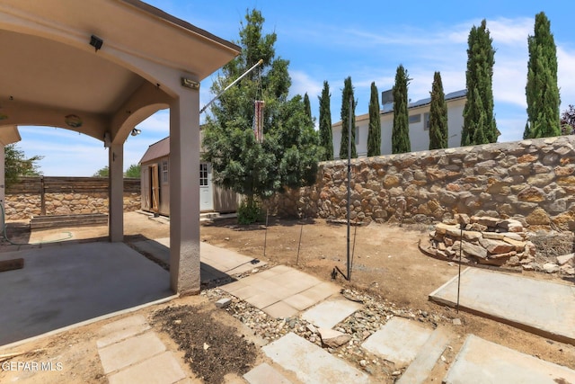 3096 Java Chip Pl, El Paso, TX 79938 - fenced backyard featuring a patio area and an outdoor structure