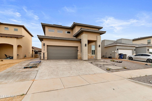 14740 Jack White Ave, El Paso, TX 79938 - view of front of home with stucco siding, a garage, concrete driveway, and stone siding