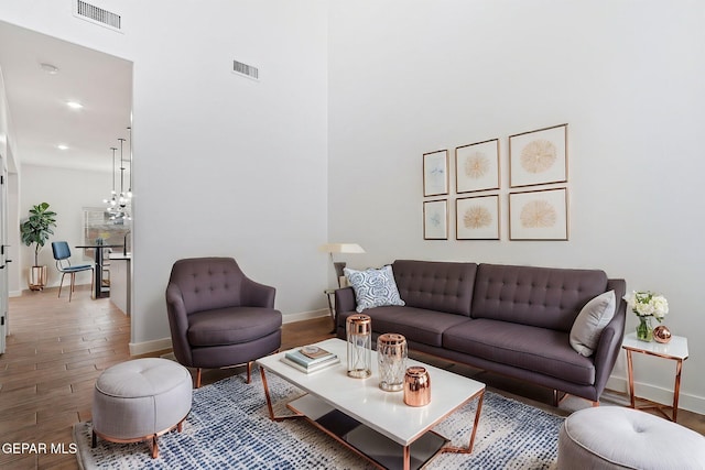 14740 Jack White Ave, El Paso, TX 79938 - living room with wood finished floors, baseboards, recessed lighting, a chandelier, and a towering ceiling