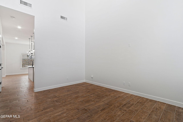 14740 Jack White Ave, El Paso, TX 79938 - empty room featuring wood finished floors, baseboards, recessed lighting, and a chandelier
