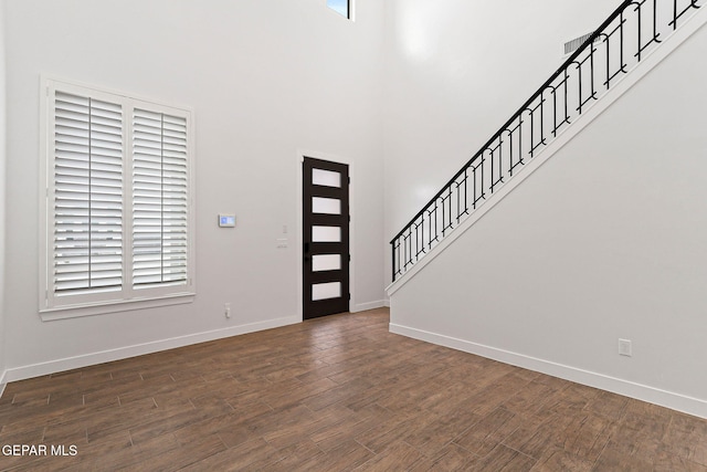 14740 Jack White Ave, El Paso, TX 79938 - foyer featuring baseboards, dark wood-style flooring, and a high ceiling