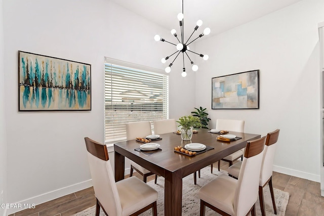 14740 Jack White Ave, El Paso, TX 79938 - dining room featuring a chandelier, baseboards, and wood finished floors