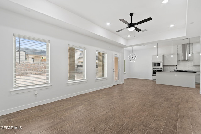 14740 Jack White Ave, El Paso, TX 79938 - unfurnished living room with a chandelier, a ceiling fan, wood finished floors, recessed lighting, and baseboards