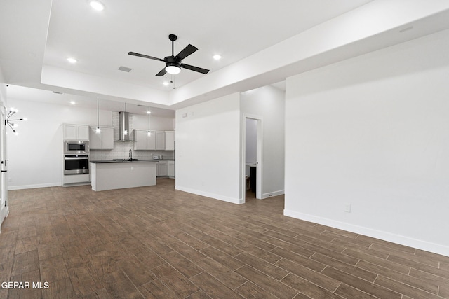 14740 Jack White Ave, El Paso, TX 79938 - unfurnished living room with ceiling fan, dark wood finished floors, baseboards, and recessed lighting
