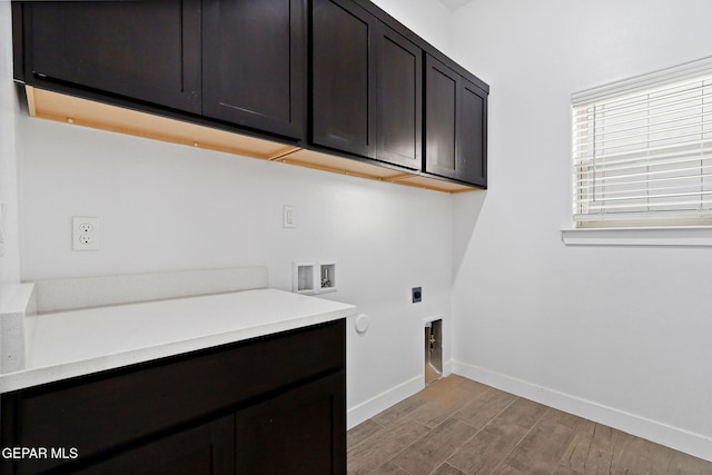14740 Jack White Ave, El Paso, TX 79938 - clothes washing area featuring hookup for an electric dryer, cabinet space, light wood finished floors, baseboards, and gas dryer hookup