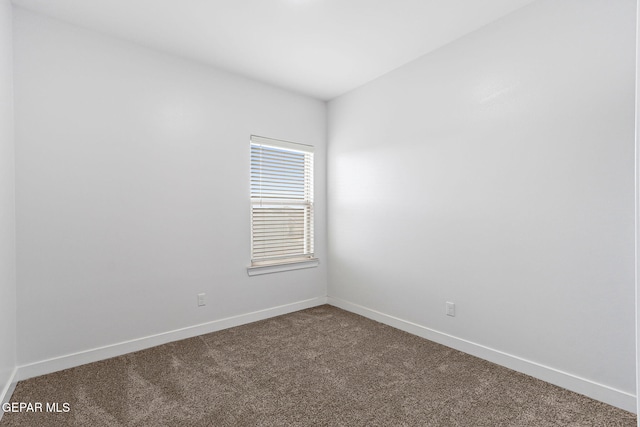 14740 Jack White Ave, El Paso, TX 79938 - empty room featuring dark colored carpet and baseboards