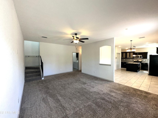 13192 Lost Willow, El Paso, TX 79938 - unfurnished living room with light carpet, a chandelier, stairway, a ceiling fan, and light tile patterned flooring