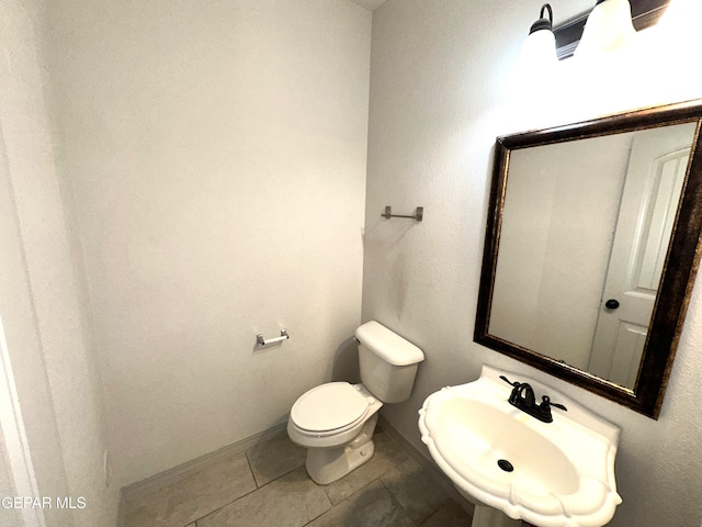 13192 Lost Willow, El Paso, TX 79938 - half bath featuring a sink, toilet, tile patterned floors, and baseboards
