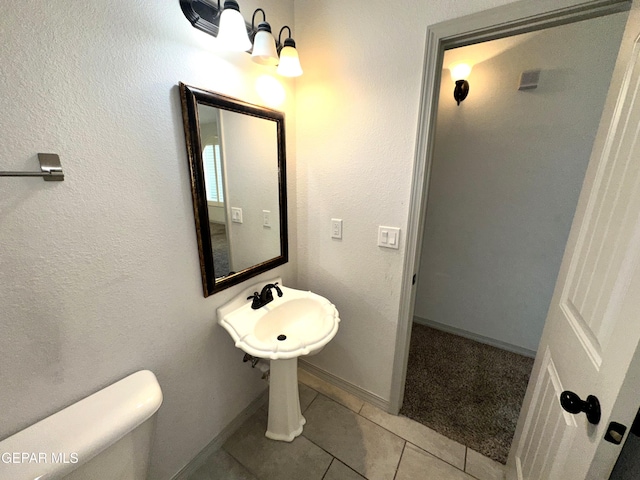 13192 Lost Willow, El Paso, TX 79938 - bathroom with tile patterned floors, toilet, and baseboards
