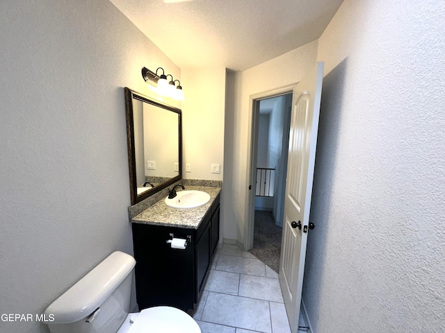 13192 Lost Willow, El Paso, TX 79938 - bathroom with a textured wall, vanity, toilet, and tile patterned floors