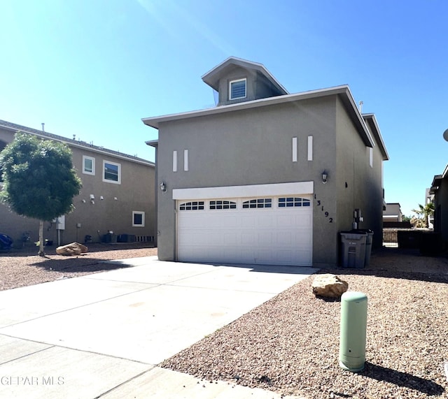 13192 Lost Willow, El Paso, TX 79938 - view of side of home featuring stucco siding and concrete driveway