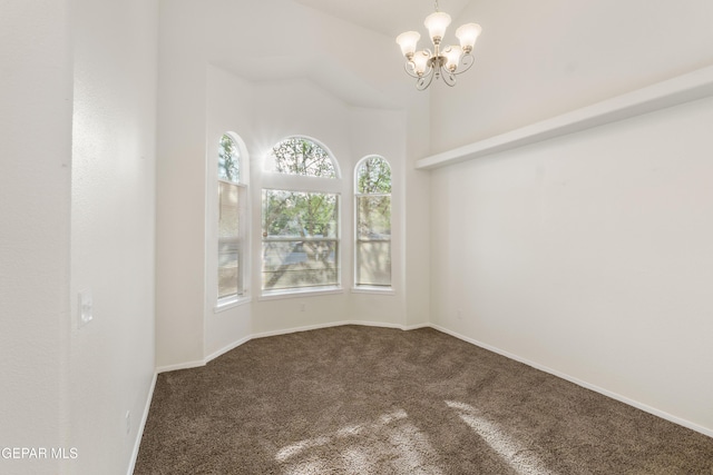 carpeted spare room featuring a chandelier and baseboards