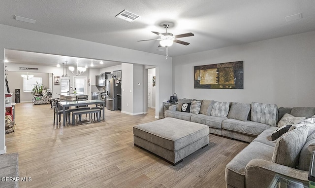 14840 Pebble Hills Blvd, El Paso, TX 79938 - living area featuring a chandelier, ceiling fan, light wood-type flooring, and baseboards