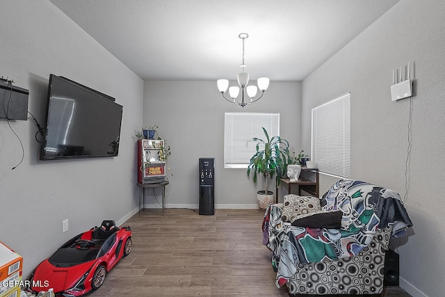 14840 Pebble Hills Blvd, El Paso, TX 79938 - sitting room with wood finished floors, a chandelier, and baseboards