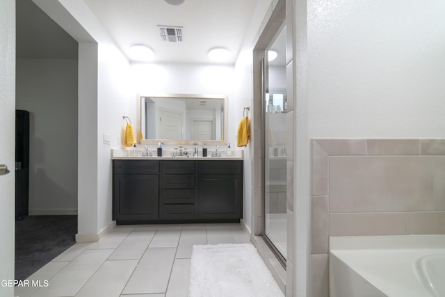 13673 Samlesbury Ave, Horizon City, TX 79928 - full bathroom with a stall shower, tile patterned flooring, double vanity, and a bath