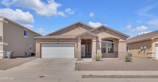 mediterranean / spanish-style house with concrete driveway, stucco siding, and an attached garage
