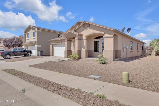 view of front of house with concrete driveway, stucco siding, and a garage
