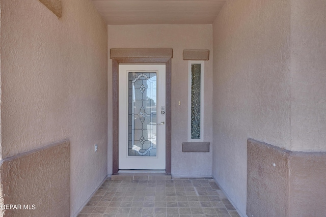 view of exterior entry with stucco siding